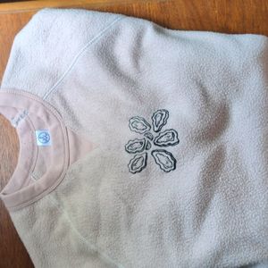 Pale pink fuzzy sweatshirt with embroidered oyster design